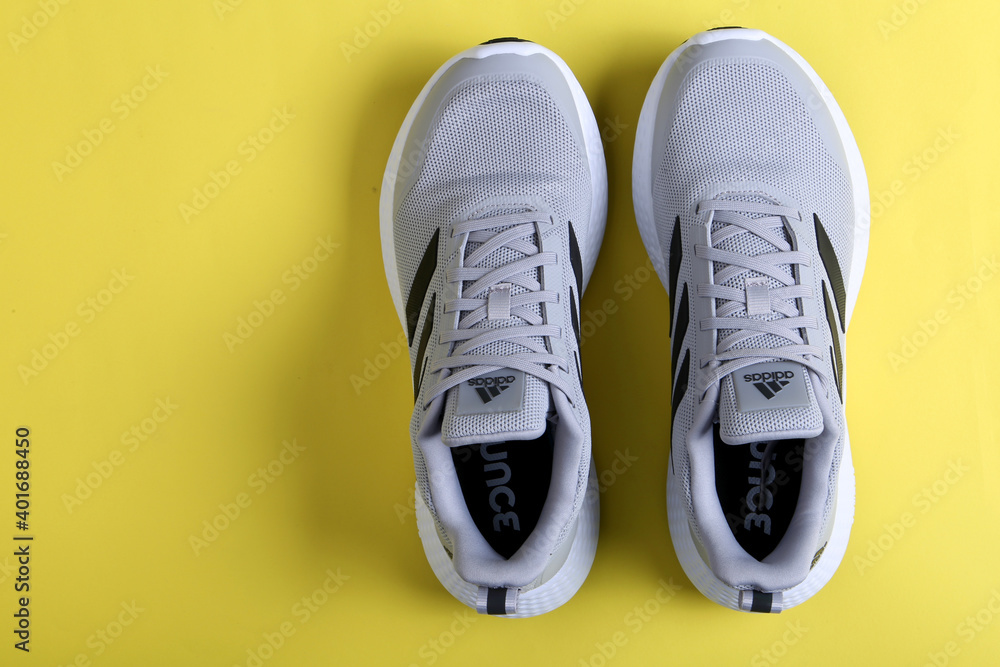 Jeddah Saudi Arabia December 26 2020: Grey Adidas Running Shoes. Adidas,  multinational company. Isolated on Black and Yellow background. Product  shots Stock Photo | Adobe Stock