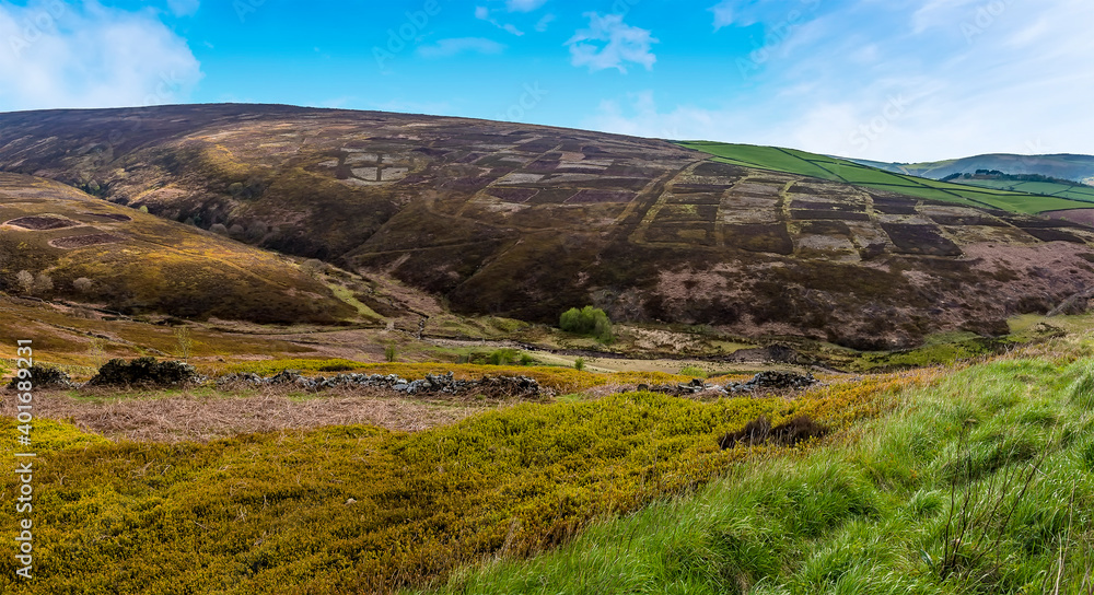 A patchwork quilt of fields across the hillside of the Dark Peak in Derbyshire, UK