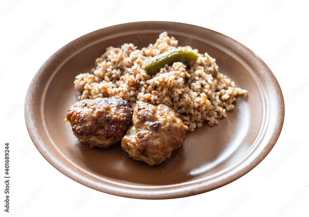 portion of fried Kotleta (breaded minced beef steaks) , side dish from boiled buckwheat porridge on brown plate cut out on white background portion of fried Kotleta (breaded minced beef steaks) , side dish from boiled buckwheat porridge on brown plate cut out on white background