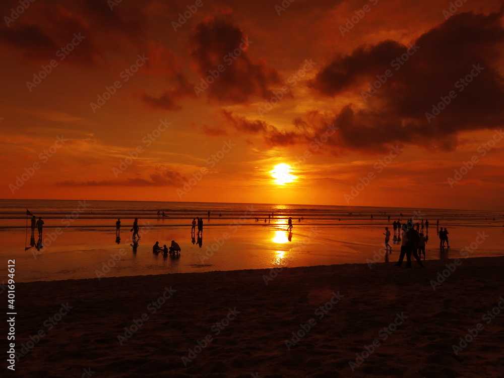 Tropical sunset in the orange sky of Kuta beach, Bali, Indonesia 