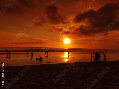 Tropical sunset in the orange sky of Kuta beach, Bali, Indonesia 