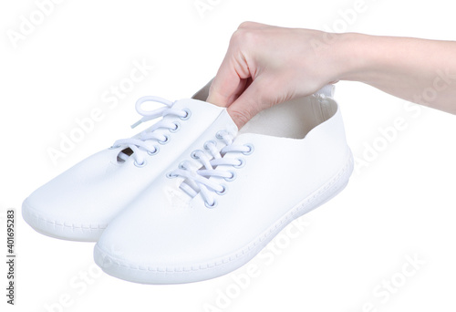 White sneakers in hand on white background isolation
