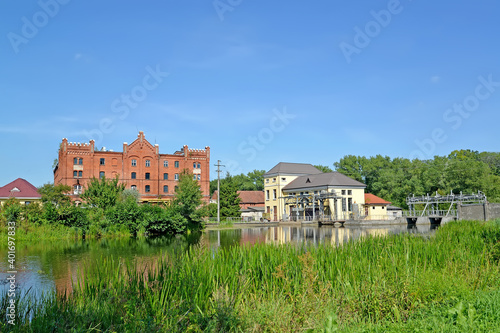 Cityscape with an old water mill and Ozerskaya hydroelectric station on the Angrap River. Ozersk, Kaliningrad region photo