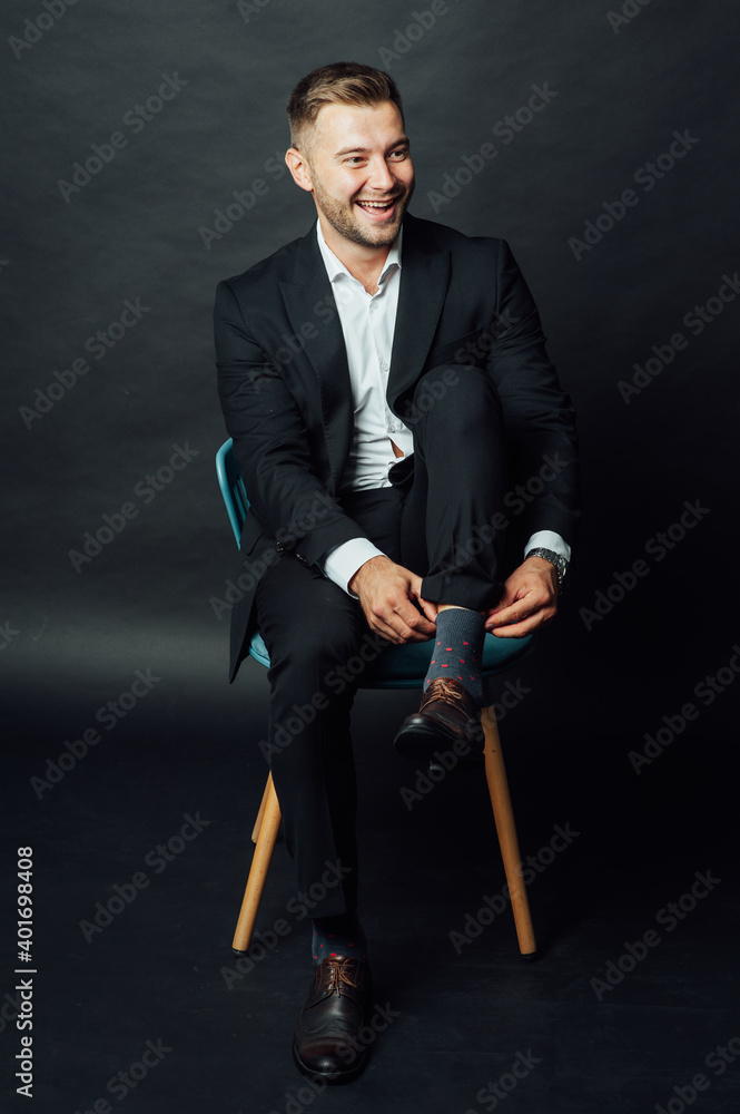 Handsome businessman man sitting on chair in photo studio Handsome businessman man sitting on chair in photo studio