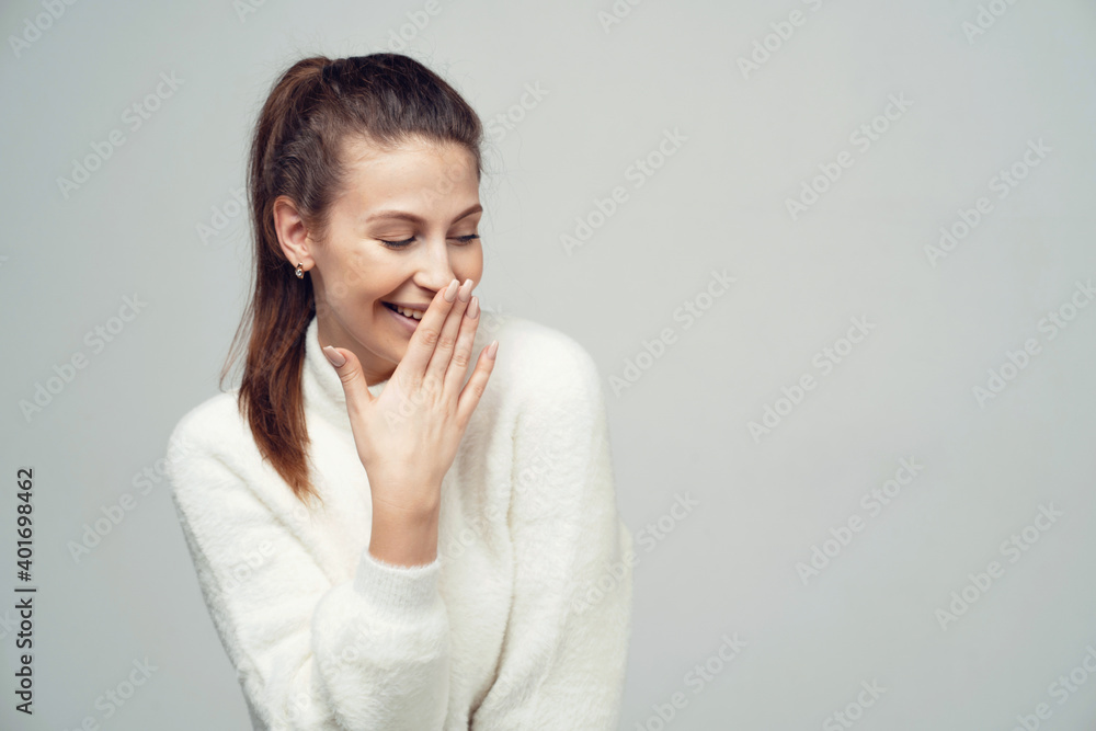 laughter, smiles, closes his mouth, looking in the direction of a brunette woman of European appearance. photo studios on a gray white background. laughter, smiles, closes his mouth, looking in the direction of a brunette woman of European appearance. photo studios on a gray white background.