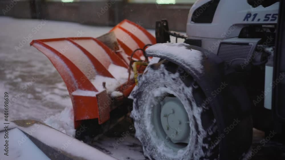 The tractor cleans the pavement in winter. Tractor cleaning the road from the snow. Excavator cleans the streets of large amounts of snow in city. A bucket close-up cleans the sidewalk from snow. The tractor cleans the pavement in winter. Tractor cleaning the road from the snow. Excavator cleans the streets of large amounts of snow in city. A bucket close-up cleans the sidewalk from snow.