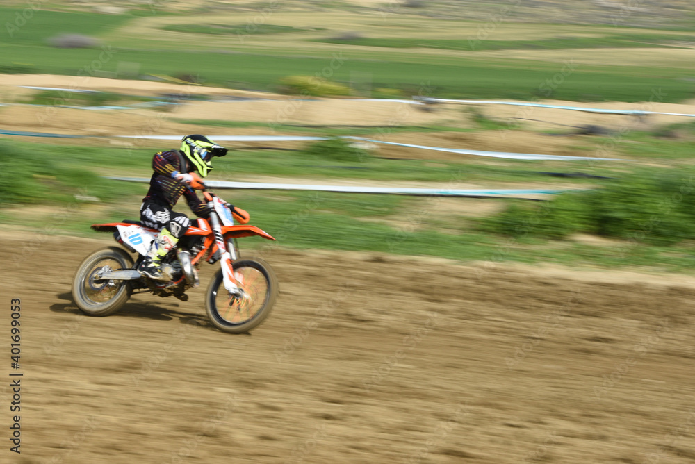 Unrecognized athlete riding a sports motorbike on a motocross racing Unrecognized athlete riding a sports motorbike on a motocross racing
