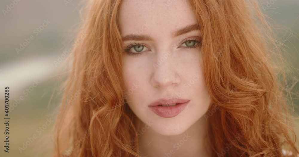 Close up shot of face of beautiful young caucasian girl with red hair ...
