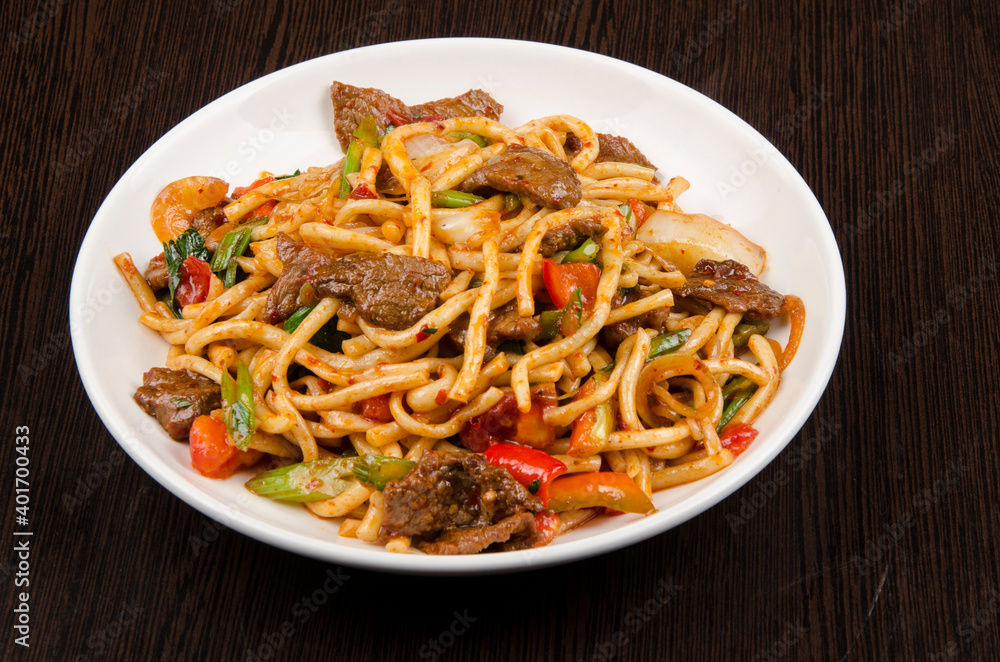 stew with pasta with pepper and onion on a white plate