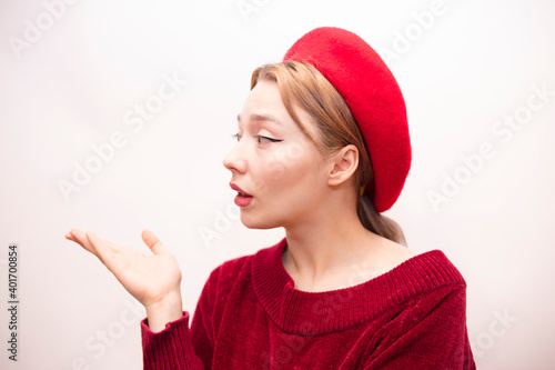 Young beautiful girl in a red beret isolated on a white background