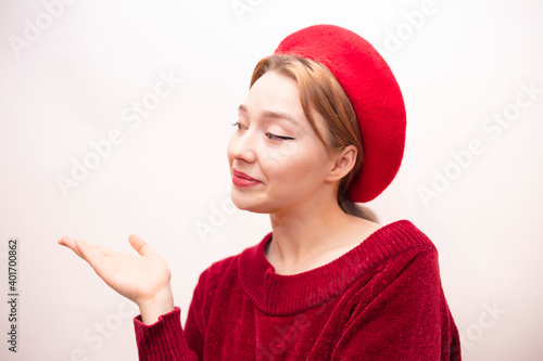 Young beautiful girl in a red beret isolated on a white background