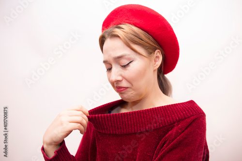 Young beautiful girl in a red beret isolated on a white background