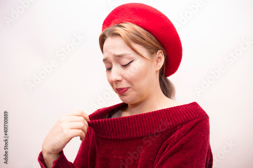 Young beautiful girl in a red beret isolated on a white background