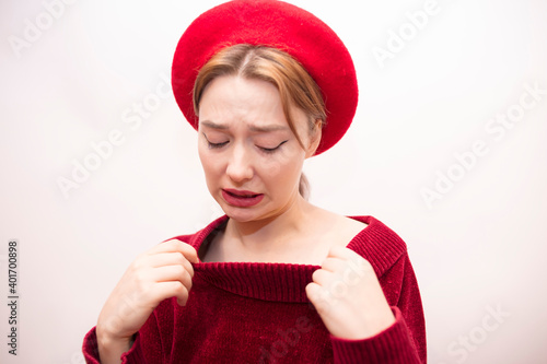 Young beautiful girl in a red beret isolated on a white background