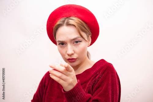 Young beautiful girl in a red beret isolated on a white background