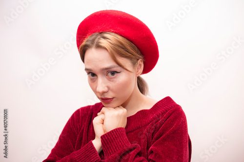 Young beautiful girl in a red beret isolated on a white background