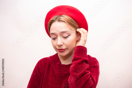 Young beautiful girl in a red beret isolated on a white background