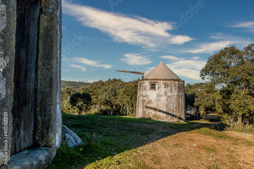 Old windmill in the middle of the mountain forest. Portuguese windmills called Moinhos da Pena photo