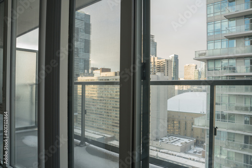 Beautiful Metropolitan Cityscape View from a Glass Condominium during Sunset with Floor to Ceiling Windows
