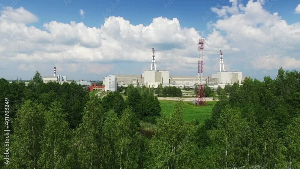 Ascending aerial view of Ignalina nuclear power plant area surounded by green nature in summer Ascending aerial view of Ignalina nuclear power plant area surounded by green nature in summer