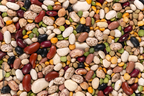 Mixed peas and beans for soup in a heart-shaped bowl background and texture. Top view.