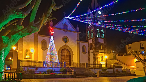 Christmas lights in a small town on the Canary Island of Tenerife, colorful, bright and with illuminated palm trees.