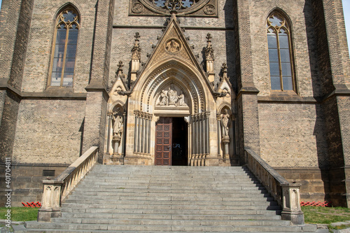 Entrance of a church in Prague with hard stone stairs and limestone ornaments.