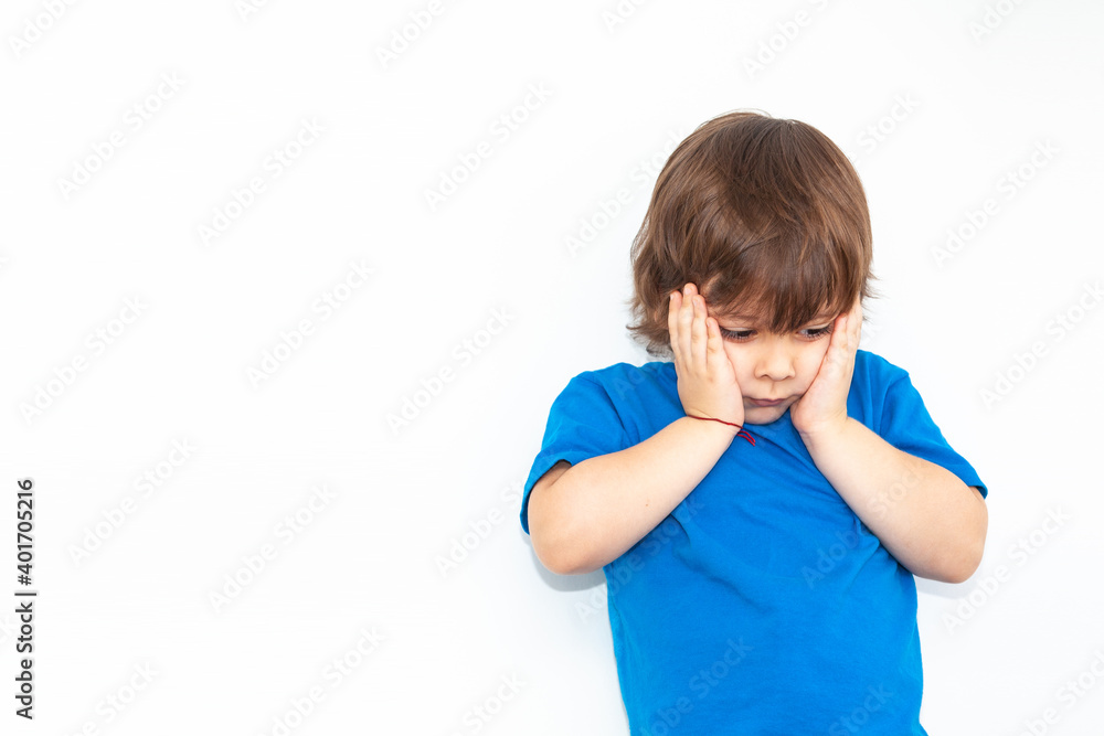 portrait of an offended boy on a light background portrait of an offended boy on a light background