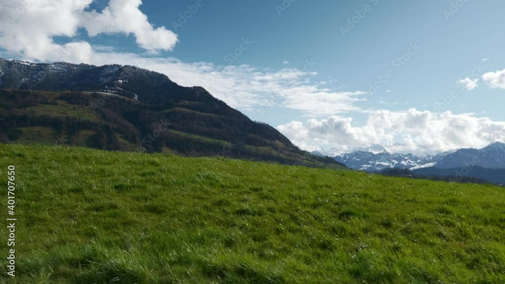 Panorama Green Pastures near Village. Scenic Snowcapped Mountain Peaks. Picturesque Valley Lake Lucerne. Switzerland Europe. Slow motion Panorama Green Pastures near Village. Scenic Snowcapped Mountain Peaks. Picturesque Valley Lake Lucerne. Switzerland Europe. Slow motion