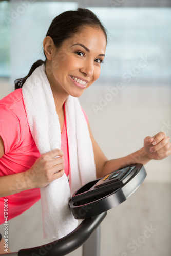 young smiling woman with towel after training photo