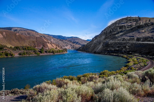 Fototapeta Naklejka Na Ścianę i Meble -  Railway and the Trans Canada Highway follow the Fraser River with its  flowing through the Canyon in the Coastal Mountain Ranges of British Columbia, Canada