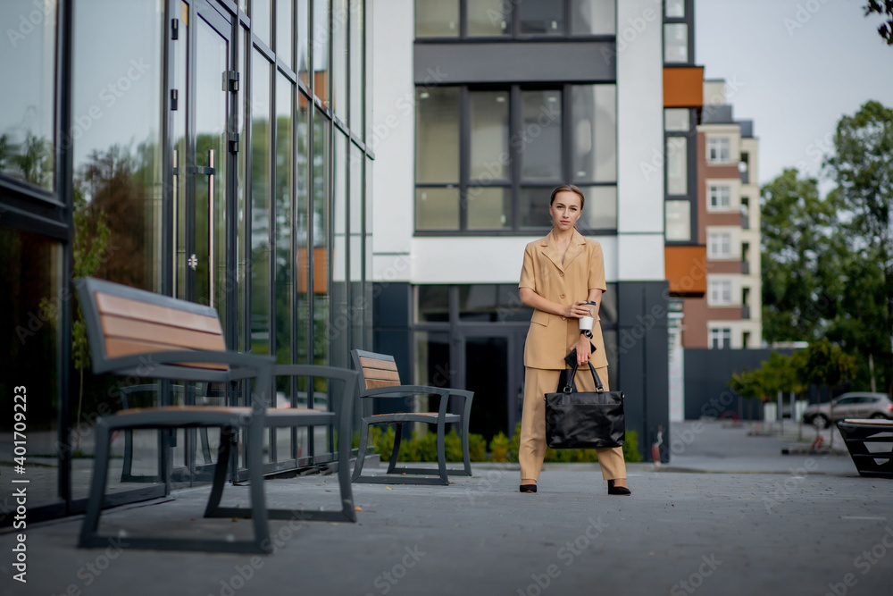 Lawyer Of Successful Business Woman Holding Cup Of Hot Drink In Hand On Her Way To Work On City Street. Caucasian businesswoman smiling happy outside.