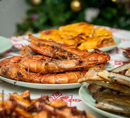 Slika na platnu A closeup of deliciously cooked caridean shrimps with spices on a plate on the t