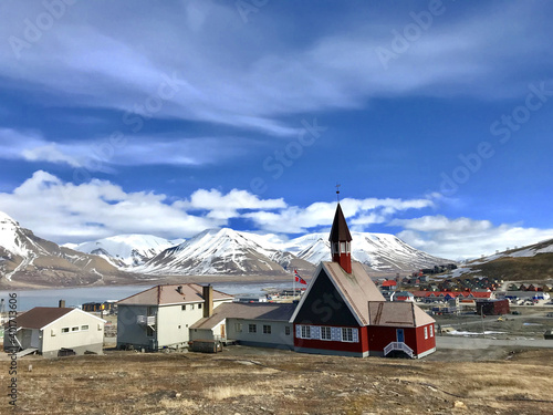 The Svalbard Church and surroundings in Longyear town, stunning mountainscape in the background, Norway photo