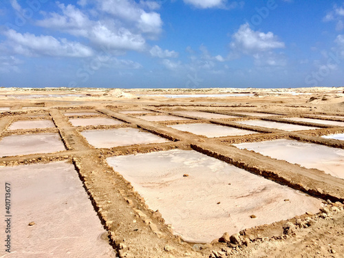 Fototapeta A closeup of salt evaporation ponds under the open sky