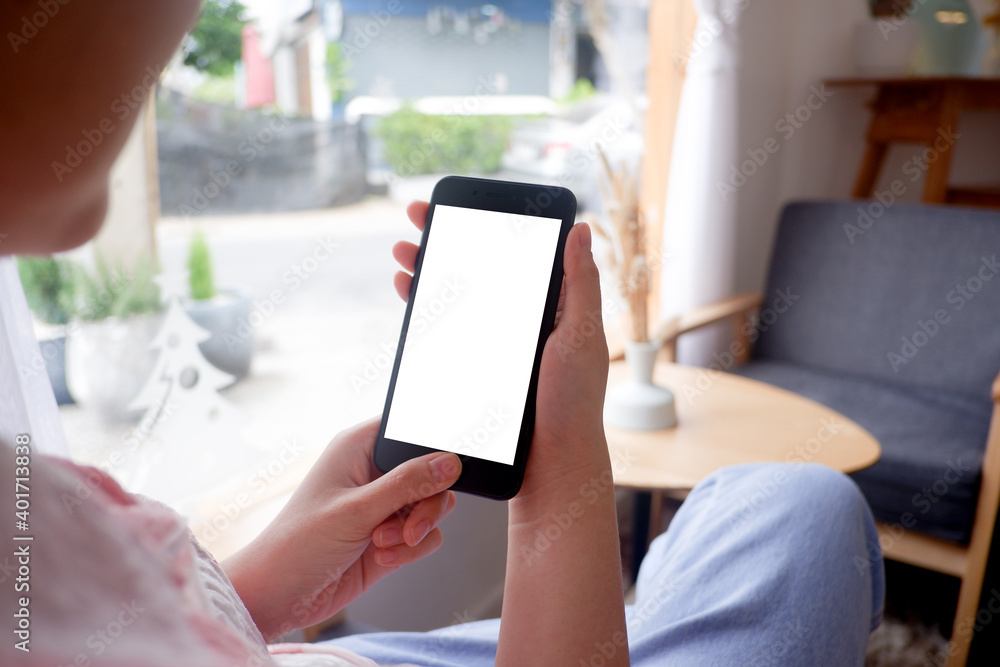 Mockup picture of business woman's hands holding smart phone with white blank screen in modern place. Mockup picture of business woman's hands holding smart phone with white blank screen in modern place.