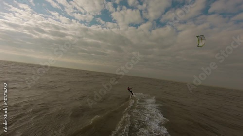 An aerial shot of a person kitesurfing in the Netherlands