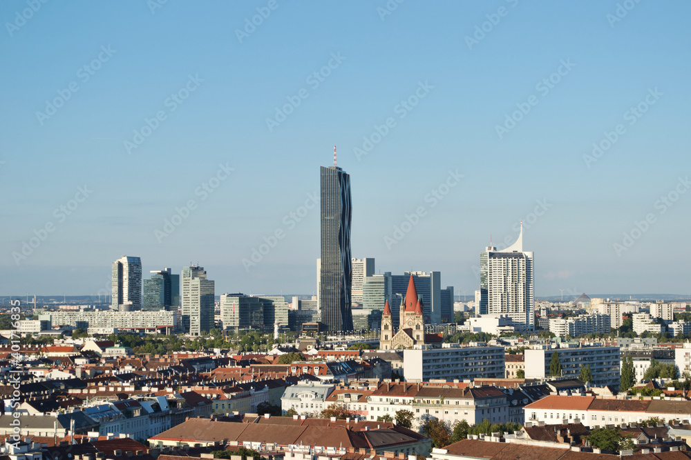 Old and new buildings in Vienna (Wien), Austria. A cityscape combining classical and contemporary metropolitan architecture, including Hochhaus Neue Donau, and the St. Francis of Assisi Church 