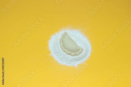 dumplings with flour on a delicate yellow background
