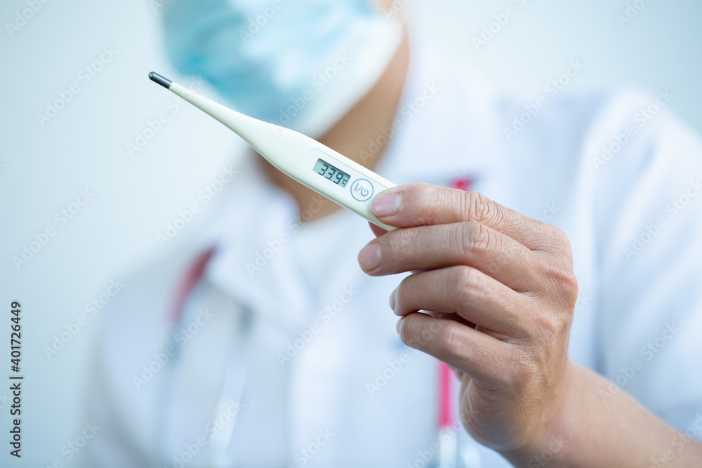 Hand of a doctor showing thermometer with stethoscope. Temperature, fever, flu or ill diagnostic equipment. Hospital tool or instrument. Hand of a doctor showing thermometer with stethoscope. Temperature, fever, flu or ill diagnostic equipment. Hospital tool or instrument.