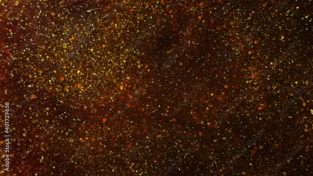 Macro shot of gold glitter. Slow mo. Amazing background. 4K. Gold liquid. Boke. Macro shot of gold glitter. Slow mo. Amazing background. 4K. Gold liquid. Boke.