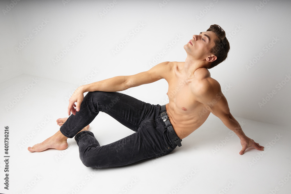 handsome man sitting on naked torso isolated background modern style handsome man sitting on naked torso isolated background modern style