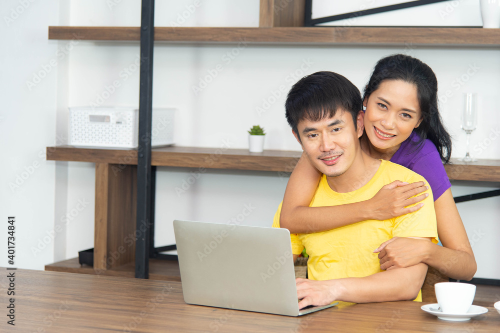 Happy and funny family. Asian lovely couple, beautiful woman and handsome man is having breakfast, talking in the kitchen Happy and funny family. Asian lovely couple, beautiful woman and handsome man is having breakfast, talking in the kitchen
