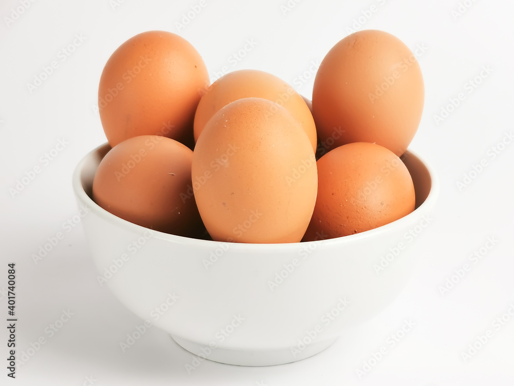 Chicken eggs in a bowl isolated on white background. Chicken eggs in a bowl isolated on white background.