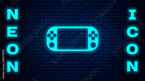 Glowing neon Portable video game console icon isolated on brick wall background. Gamepad sign. Gaming concept. Vector Illustration.
