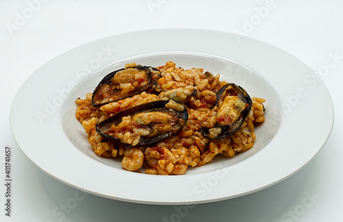 Risotto with seafood. Risotto ai frutti di mare, isolated on white background