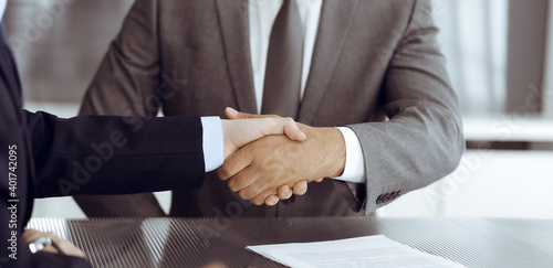 Wallpaper Mural Unknown business people are shaking hands after contract signing in modern office, close-up. Handshake as successful negotiation ending Torontodigital.ca