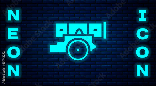 Glowing neon Cannon icon isolated on brick wall background. Vector.