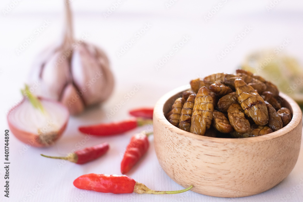 silkworm pupa in wooden bow as edible insects on white background, high protein insect
silkworm pupa in wooden bow as edible insects on white background, high protein insect