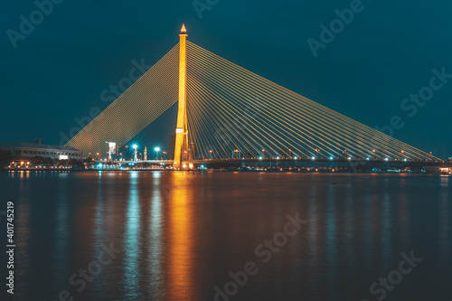 Nighttime at The Rama VIII or 8 Bridge is a cable-stayed bridge crossing the Chao Phraya River in Bangkok, Thailand. Asia.